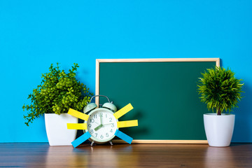 Wall Mural - Post it note paper sticky and vintage alarm clock and blank green chalkboard on table with copy space for add text notice something, list memo and schedule concept.