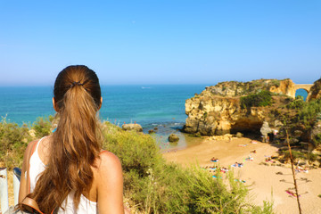 Wall Mural - traveler woman enjoying and relaxing stunning view of southern portugal. back view of beautiful girl