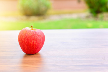 Fresh Red Apple Isolated on Wooden Table with Bright Light