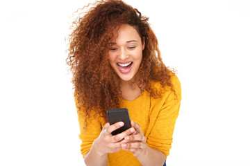 Wall Mural - Close up cheerful young woman laughing with mobile phone against isolated white background