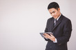 © Noey smiley - Happy businessman using digital tablet