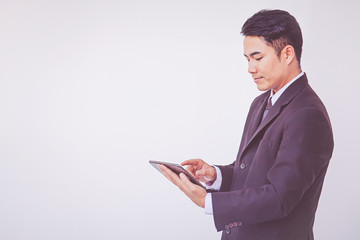 Happy businessman using digital tablet