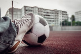Fototapeta Sport - foot of a man on a soccer ball
