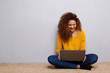 © mimagephotos - happy young woman sitting on floor with laptop