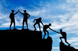 Silhouette of five climbers who overcome the drudgery of working in a team