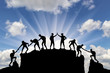 Silhouette of climbers who climbed to the top of the mountain thanks to mutual assistance