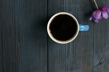 Wall Mural - A cup of black coffee and an anemone flower