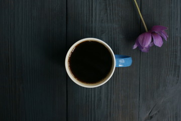 Wall Mural - A cup of black coffee and an anemone flower