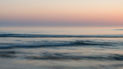 Beautiful colorful vibrant sunrise over low tide beach landscape peaceful scene