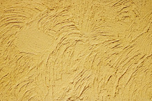 Background: Texture Of Yellow Decorative Plaster On The Wall