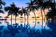 Summer Beach Holiday Vacation Destination, Luxurious Beachfront Resort Swimming Pool With Tropical Landscape, Quiet Warm Sunset, Silhouette And Reflection In Water