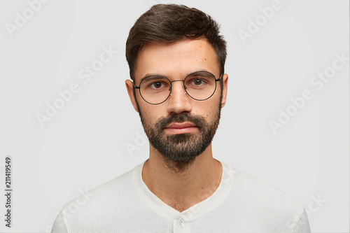 Close Up Portrait Of Handsome Unshaven Male With Thick Beard And