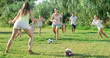 © JackF - Group of happy people with kids playing football together