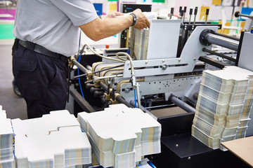 Worker at machine for packing