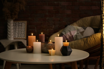 Wall Mural - Burning candles on table indoors