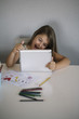 © karrastock - Little girl using a tablet at home