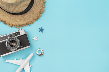 Wall Mural - Retro camera with toy plane on pastel blue background with copy space