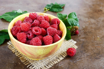 Wall Mural - Fresh ripe tasty raspberries in a yellow ceramic bowl. Summer berries.