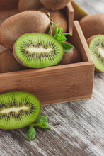 Green Kiwis And Mint Leaves In The Wooden Tray