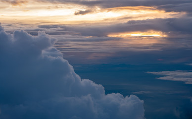 Wall Mural - Aerial view of sunset with big cloud at evening sky view on airplane transportation.travel lifestyle.hope concept.