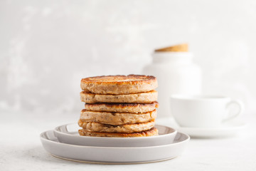 homemade pancakes with chia seeds on a white plate, white background. healthy vegan food concept.