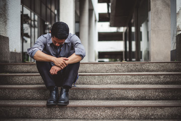 Upset asian businessman tired from work sitting, unemployment, fired from job, disappointed, loss and feeling down concept