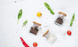 © voloshin311 - Herbs and spices in jars over on white wooden table. Ingredients for cooking