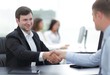 © ASDF - handshake business partners at your Desk