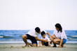 © ic36006 - Happy family on the beach. Parents with Children enjoying a holiday at the sea. Summer vacation concept
