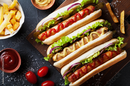 Fotografía Barbecue grilled hot dog with sausage and yellow mustard with ketchup top view