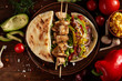 Exotic still slife with pita, fresh vegetables and kebab over wooden background, selective focus.