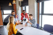 © alfa27 - Well-known female designer with violet dyed hair visiting company of young designers. Business People of different races meeting at modern office to discuss developing strategy