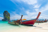 Fototapeta Morze - Thai long tail boats on the beach with beautiful island, Krabi Phuket Thailand