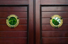 Window Porthole With Reflection Of Green Foliage On Wooden Surface, Concept Of Antique Objects, Natural Light, Copy Space, Closeup.