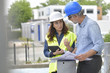 © goodluz - Construction engineers meeting outside building
