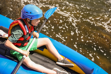 Wall Mural - little boy kayaking on river. summer camp