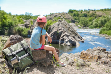 Wall Mural - little girl on rock near river. summer camp