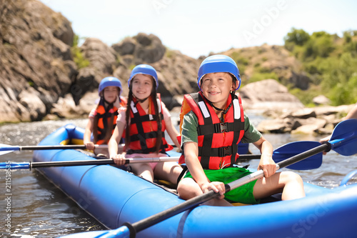 Cuadros en Lienzo Little children kayaking on river. Summer camp