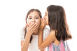 © AntonioDiaz - Younger sister whispering news to older sister's ear