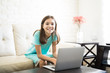 © AntonioDiaz - Portrait of a girl child sitting at home using laptop