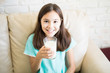© AntonioDiaz - Close up portrait of adorable little latin girl drinking glass of milk