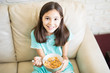 © AntonioDiaz - Closeup portrait of a young girl enjoying cereal cornflakes as snacks