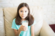 © AntonioDiaz - Portrait of cute latin child with  glass of milk look at the camera