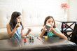 © AntonioDiaz - Small sisters applying lipstick and foundation with cosmetic products