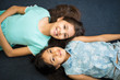 © AntonioDiaz - Happy sisters lying on floor with head to head