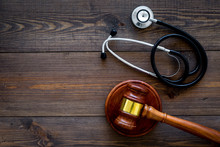 Medical Law, Health Law Concept. Gavel And Stethoscope On Dark Wooden Backgound Top View Copy Space