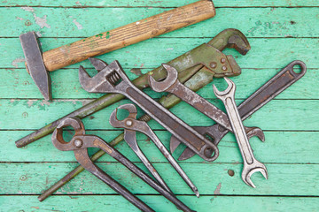 Wall Mural - Set of old tools. Green painted wooden background