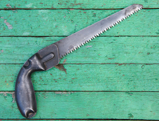 Wall Mural - Old hack-saw on wooden background