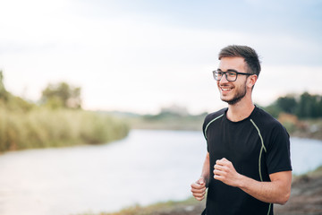 Young Man Running By the River