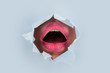 © Tverdokhlib - Surprise. Female mouth in colored with pink lipstick is through hole in paper. Seductive female mouth is open in torn paper. Women sexy mouth inside. Scream and the right to vote. Feminism and voting
